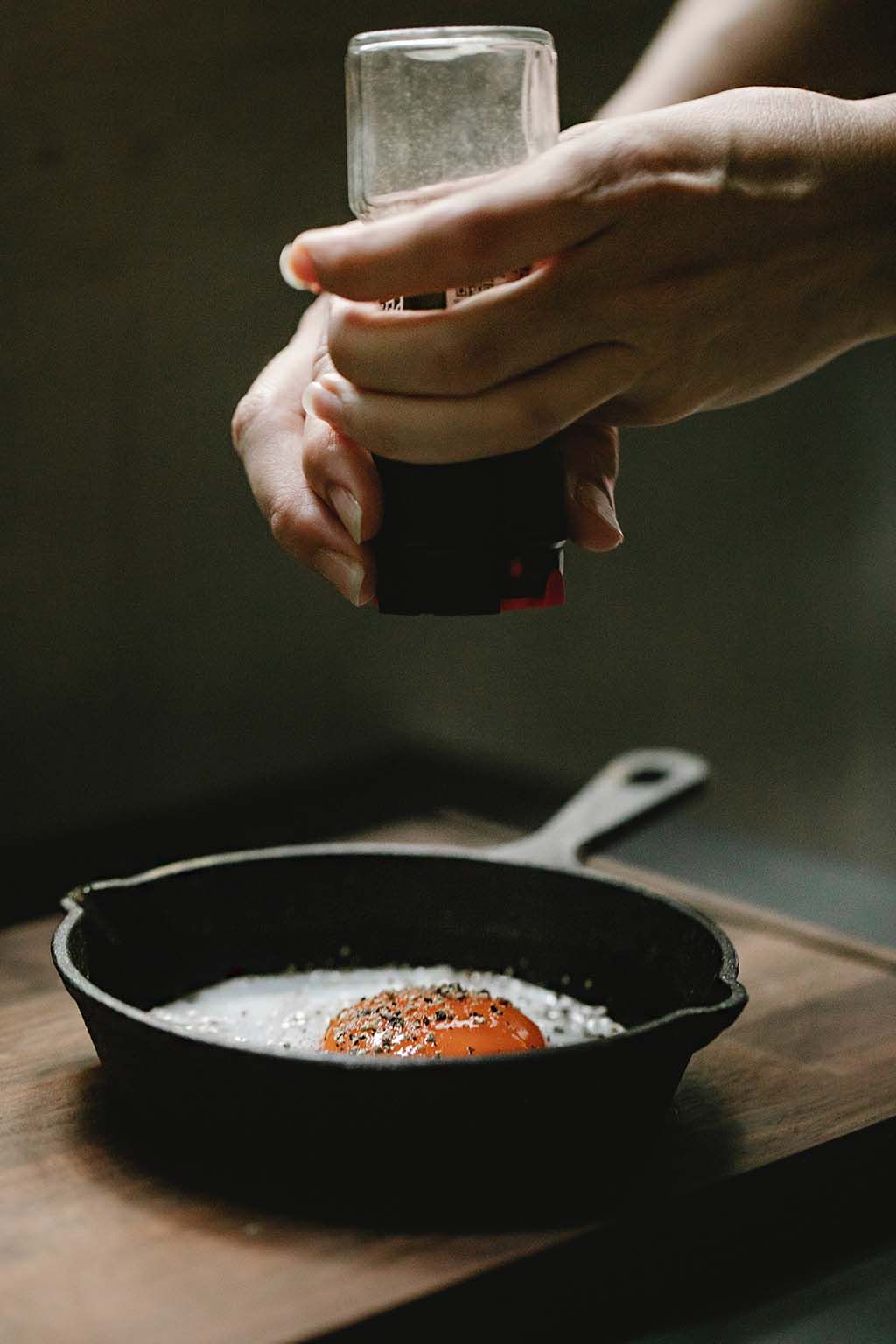 cast iron pan frying egg - klaus-nielsen